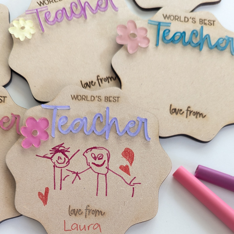 Close-up view of a personalized "World's Best Teacher" magnet, featuring colorful acrylic lettering and space for custom decoration, perfect for teacher appreciation gifts.