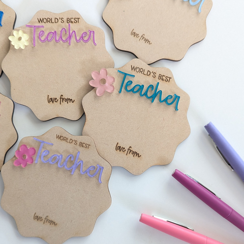 Multiple "World's Best Teacher" personalized magnets made from acrylic, with colors chosen at random, perfect for gifting and personalization. Includes space for a hand-drawn message or name.